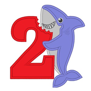 May include: A red number two with a blue shark biting into it. The shark has a white belly and a toothy grin.
