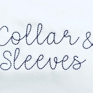 May include: White background with the words "Collar & Sleeves" embroidered in dark blue thread. The text is in a cursive font, with the letters connected. The embroidery has a textured appearance.