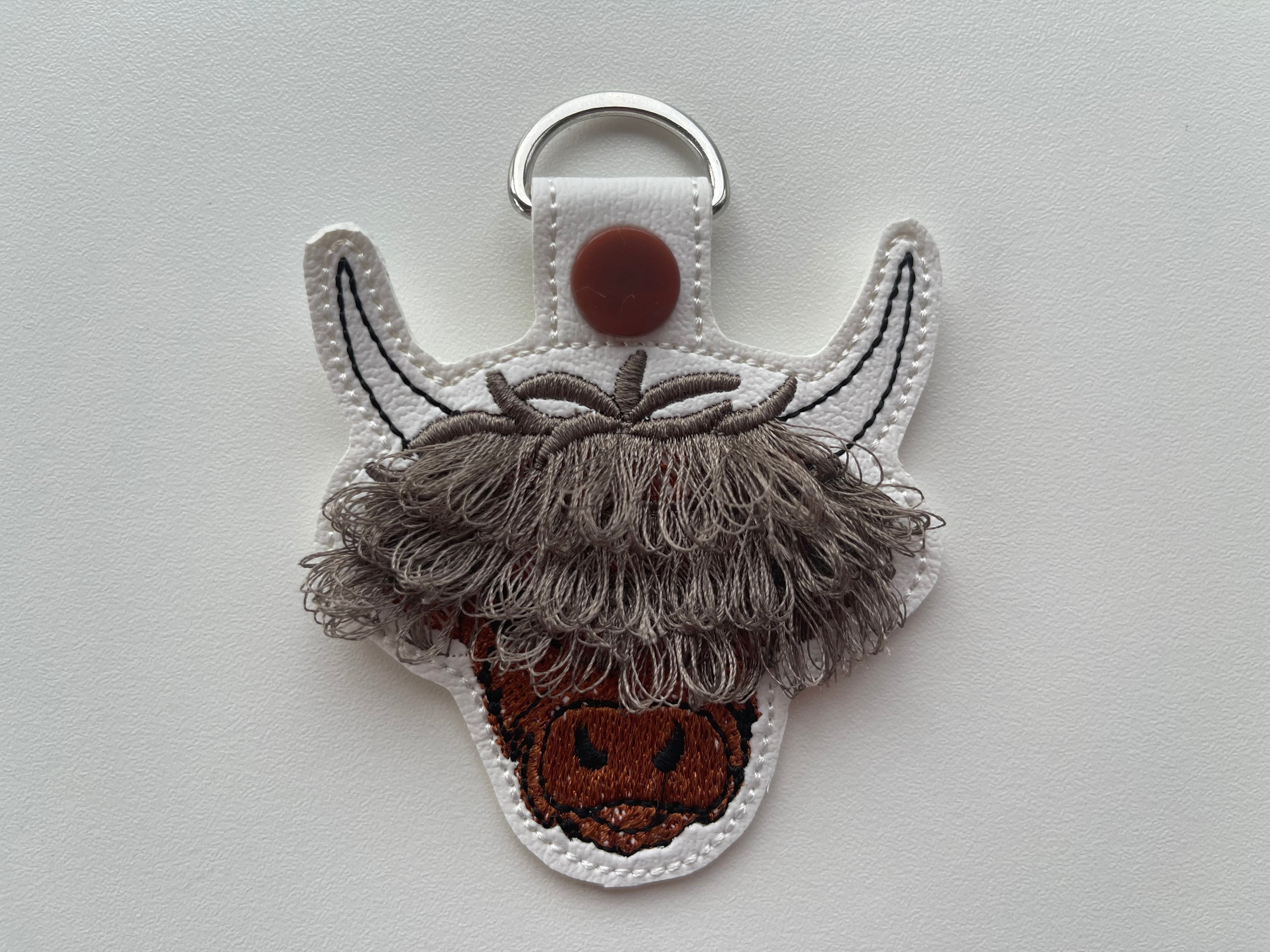 Fringed Highland cow keychain key fob snap tab in the hoop machine embroidery designs ITH project Awesome fluffy fur cow kids backpack tag