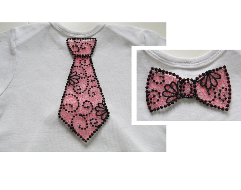 May include: A white t-shirt with a pink and black tie applique. The tie has a decorative design of swirls and flowers. A separate image shows a pink and black bow tie with the same design.