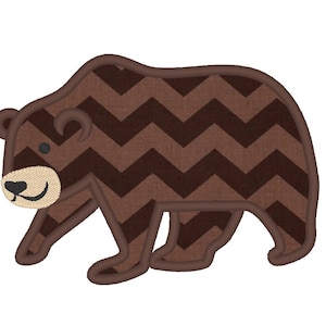 May include: Brown bear applique with a chevron pattern. The bear has a simple smiling face with black eyes and a brown nose.