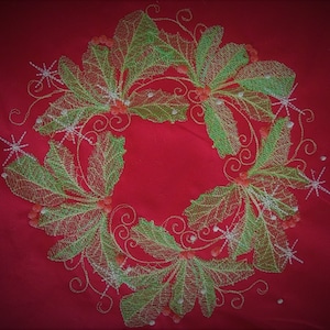 May include: Embroidered Christmas wreath design with green leaves, red berries, and white snowflakes on a red background.