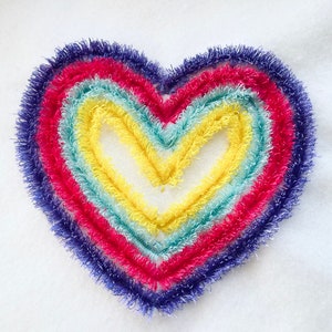 May include: A heart-shaped rainbow made of fuzzy yarn in shades of purple, pink, blue, green, and yellow.