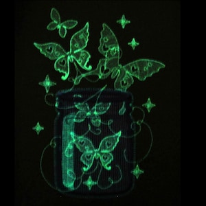 May include: A green glow-in-the-dark mason jar with a lid and butterflies flying out of the top. The jar is filled with more butterflies and stars.