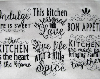 May include: Black and white embroidered kitchen towel with the text "Indulge Life is Sweet", "This kitchen is seasoned with Love", "Bon Appetit", "The Kitchen is the heart of the Home", "Live life with a little Spice", and "Kitchens are made for bringing families together".