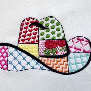 May include: A colourful patchwork design of a cowboy hat with a black outline. The hat is made up of different patterns, including hearts, polka dots, flowers, and geometric shapes.