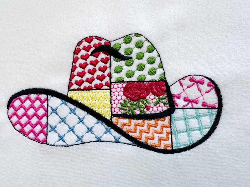 May include: A colourful patchwork design of a cowboy hat with a black outline. The hat is made up of different patterns, including hearts, polka dots, flowers, and geometric shapes.