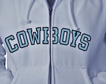 May include: A light blue zip-up hoodie with the word "COWBOYS" printed in a blue and black font.