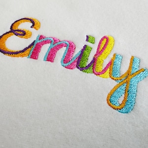 May include: Embroidered name "Emily" in a colorful rainbow font on a white background.