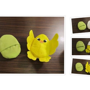 May include: A yellow felt chick with black eyes and an orange beak is sitting inside a green felt egg. The egg is open and the chick is peeking out.