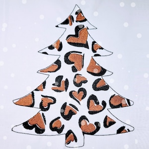 May include: A white Christmas tree with a brown and black leopard print design.