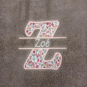 May include: A brown plush blanket with a pink floral embroidered letter Z and the name "Zo&eacute;" embroidered in white.