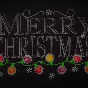 May include: Embroidered design on a black background that says "Merry Christmas" with a string of colorful lights underneath.