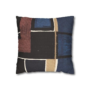 May include: Square throw pillow with a geometric pattern. The design features a black background with rectangular shapes in shades of blue, burgundy, and tan, outlined with white lines. The pillow has a textured appearance.