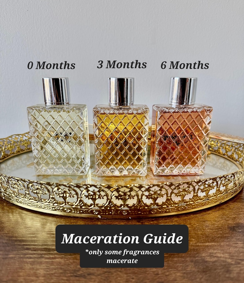 May include: Three perfume bottles with silver caps sit on a gold-rimmed tray. The bottles are labeled "0 Months", "3 Months", and "6 Months", showing the color change over time. The text "Maceration Guide" is below the bottles.