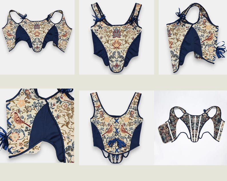 Op de afbeelding: Een verzameling cr&egrave;mekleurige korsetten met een bloemen- en vogelpatroon, geaccentueerd met marineblauwe panelen en afwerking. De korsetten hebben verschillende bandjes en strikdetails, wat een vintage esthetiek laat zien.