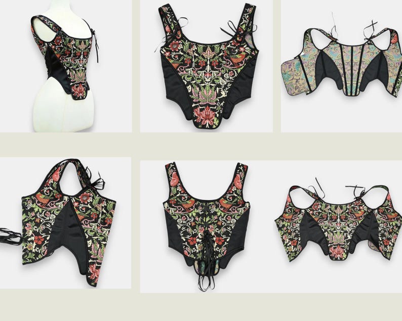 Op de afbeelding: Een collectie zwarte korsetten met bloemenborduurwerk in rood, groen en goud. De korsetten hebben verschillende bandjes en strikdesigns, die een reeks stijlen laten zien. De stof lijkt een mix van satijn en geborduurd materiaal te zijn.