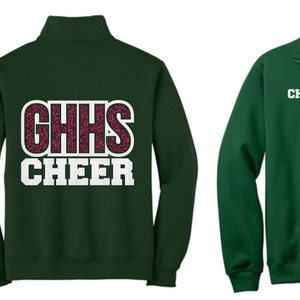 May include: A dark green fleece zip-up sweatshirt with a white and pink glitter design that says "GHHS CHEER" on the back and "CHLOE" on the front.