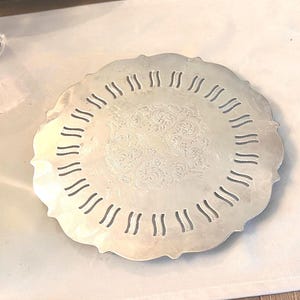 May include: A set of three ceramic canisters with lids. The canisters are white with a blue floral pattern. The largest canister is 8 inches tall, the medium is 7 inches, and the smallest is 6 inches.