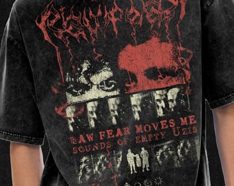 May include: Dark gray t-shirt with a distressed graphic design. The design features red and white text and imagery, including a skull and faces. The text reads "RAW FEAR MOVES ME SOUNDS OF EMPTY UZIS" and "Twenty Nine Watts Breach".
