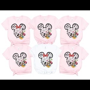 six pink t-shirts with Disney-themed designs, including Mickey Mouse and Minnie Mouse motifs, printed on them.