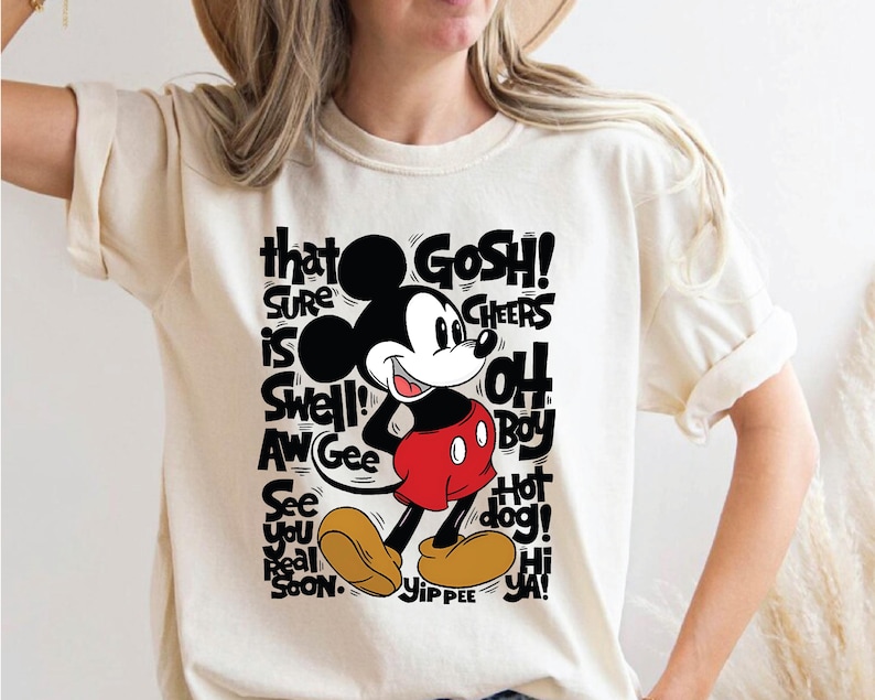 a woman wearing a mickey mouse t - shirt