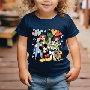 a little girl wearing a mickey mouse shirt