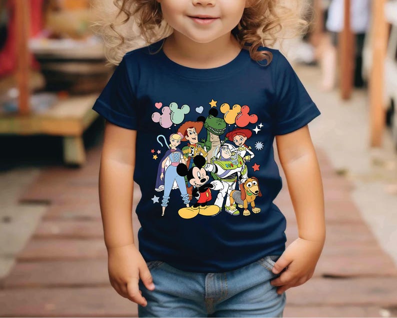 a little girl wearing a mickey mouse shirt