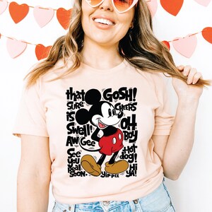 a woman wearing a t - shirt with a mickey mouse on it