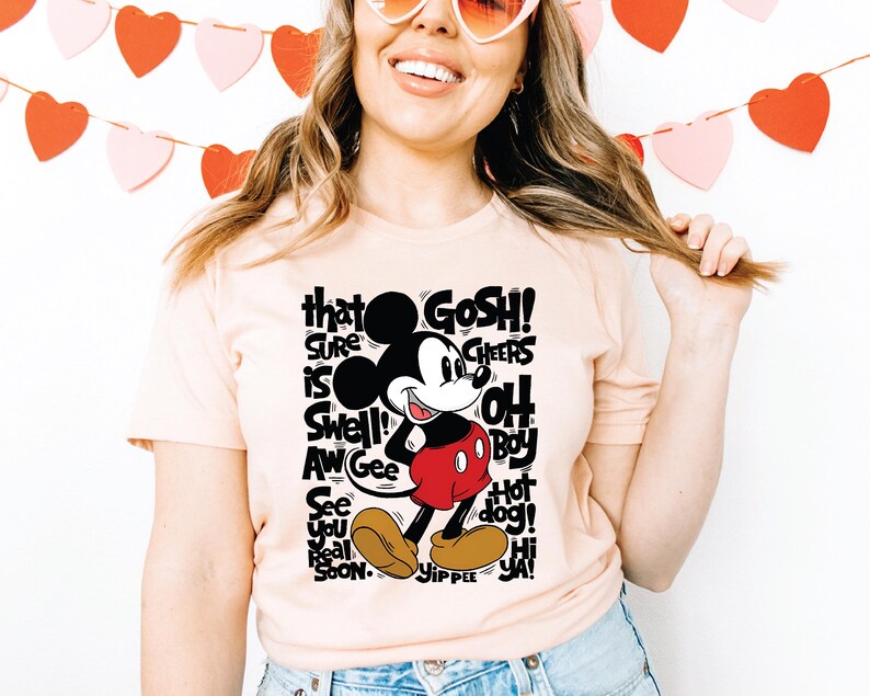 a woman wearing a t - shirt with a mickey mouse on it