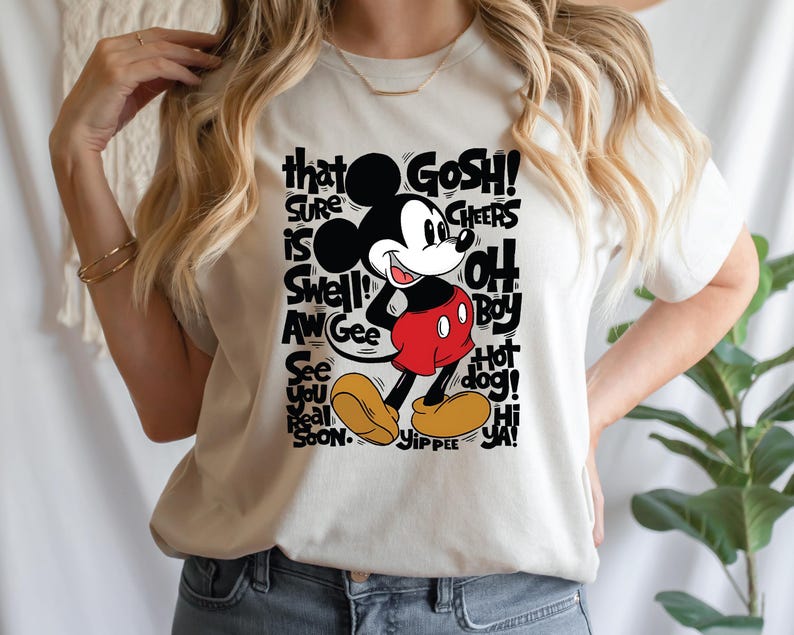 a woman wearing a mickey mouse t - shirt