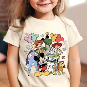 a little girl wearing a mickey mouse t - shirt