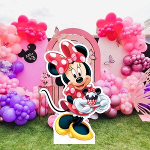 Cheerful Minnie Mouse Birthday Cutout Includes Mickey, Minnie, Donald and daisiy duck Mockup on the wooden and size guide featuring Mickey Mouse Characters Perfect for Kids Party. Editable Canva Temple