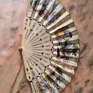Antique ivory fan with a painted gallant scene and gilt decoration. Very well preserved.