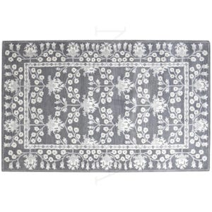 May include: A rectangular area rug featuring a dark gray background with a contrasting white floral pattern. The design includes a central motif of branching flowers and leaves, surrounded by a decorative border of repeating floral elements.