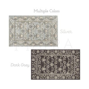 May include: Two rectangular rugs featuring a floral vine pattern with a decorative border. The top rug is silver with light gray floral motifs, and the bottom rug is dark gray with light gray floral motifs. The text Multiple Colors, Silver, and Dark Grey is visible.