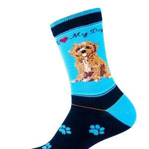 May include: A blue and black sock with a dog graphic. The sock features a light blue background with a brown dog illustration and the text "I ❤️ My Dog". The lower portion of the sock is black with light blue paw prints.