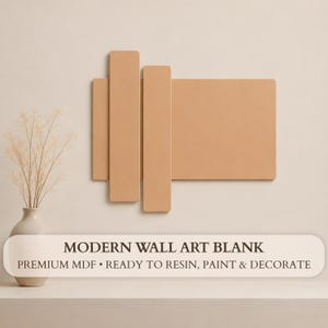 May include: A light tan wall art blank made of MDF, featuring a rectangular base with two vertical rectangular panels layered on top. The text reads: MODERN WALL ART BLANK, PREMIUM MDF • READY TO RESIN, PAINT & DECORATE.
