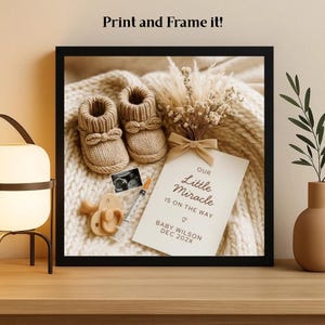 May include: A framed print featuring baby booties, a pacifier, and a sonogram image. The print includes a card with the text "Our Little Miracle Is On The Way" and the name "Baby Wilson" and the date "DEC 202X". The frame is black.