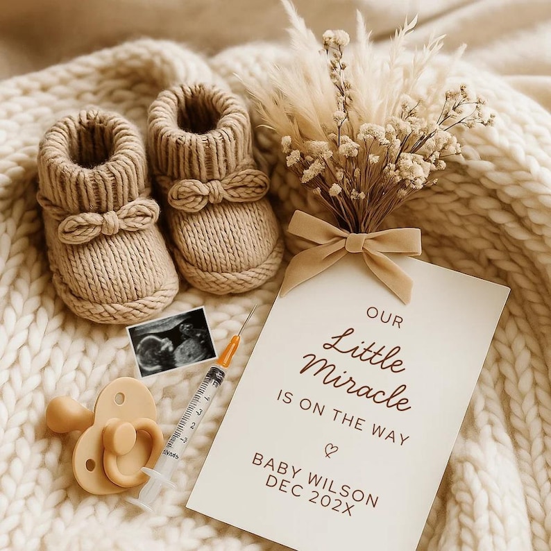 May include: A beige-colored baby announcement scene featuring knitted booties with bow accents, a pacifier, a syringe, and a sonogram image. A card reads "Our Little Miracle Is On The Way" with a baby's name and due date. Dried flowers and a soft blanket complete the scene.