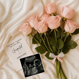 May include: A bouquet of light pink roses with green stems and leaves, tied with a pink ribbon. Beside the flowers is a card with the text "THE BEST THINGS IN LIFE ARE Unexpected" and a sonogram image. The card also reads "MARCH 202X".