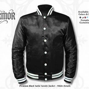 May include: A black satin varsity jacket with white detailing. The jacket has a button-up front, white collar, cuffs, and hem stripes. The text "NURMOR" is at the top left. The text "Available in All Colors & Sizes" and "Completely Customizable" are on the right.