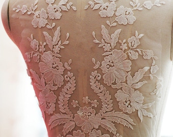May include: White floral lace applique with delicate embroidery, perfect for adding a touch of elegance to wedding dresses, bridal accessories, or other craft projects.