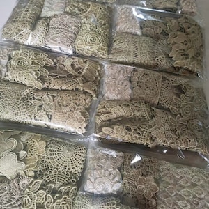 May include: Assortment of gold lace trim in various patterns and designs. The lace is packaged in clear plastic bags.