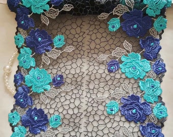 May include: Teal and navy blue floral lace trim with a black mesh background. The lace features a repeating pattern of flowers and leaves.