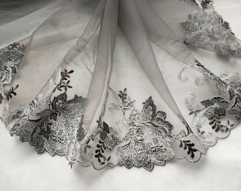May include: Silver and brown floral embroidery on a sheer gray tulle fabric.