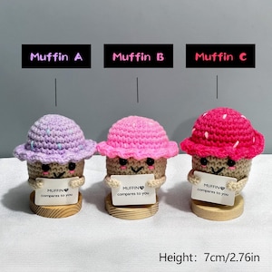 May include: Three handmade crochet muffins with smiling faces, each holding a sign that reads "MUFFIN compares to you." The muffins have different colored tops: lavender, pink, and red. Each muffin is approximately 2.76 inches tall.