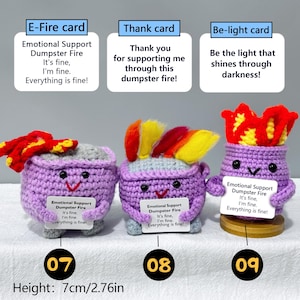 May include: Three handmade crochet figures with purple bodies, each with a different colorful flame-like top. Each figure holds a card with the text "Emotional Support Dumpster Fire." The height is 2.76 inches.