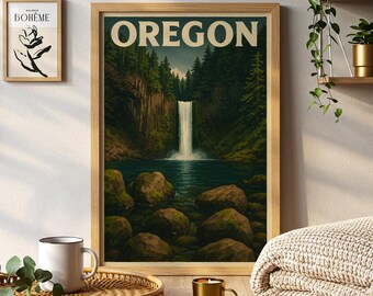 May include: A framed print featuring a scenic waterfall in Oregon, with the state's name in bold letters at the top. The artwork is in a wooden frame and depicts a lush forest and a cascading waterfall. A smaller framed art piece is visible to the left.