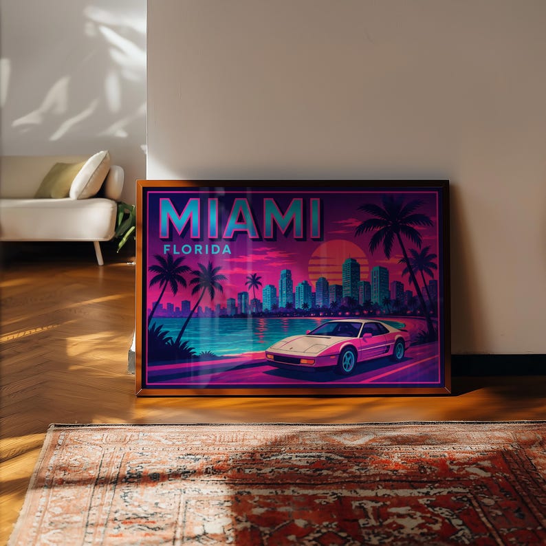 May include: Framed art print featuring a retro Miami, Florida design. The artwork showcases a pink sports car, palm trees, and a cityscape against a vibrant sunset. The word "MIAMI" is prominently displayed.